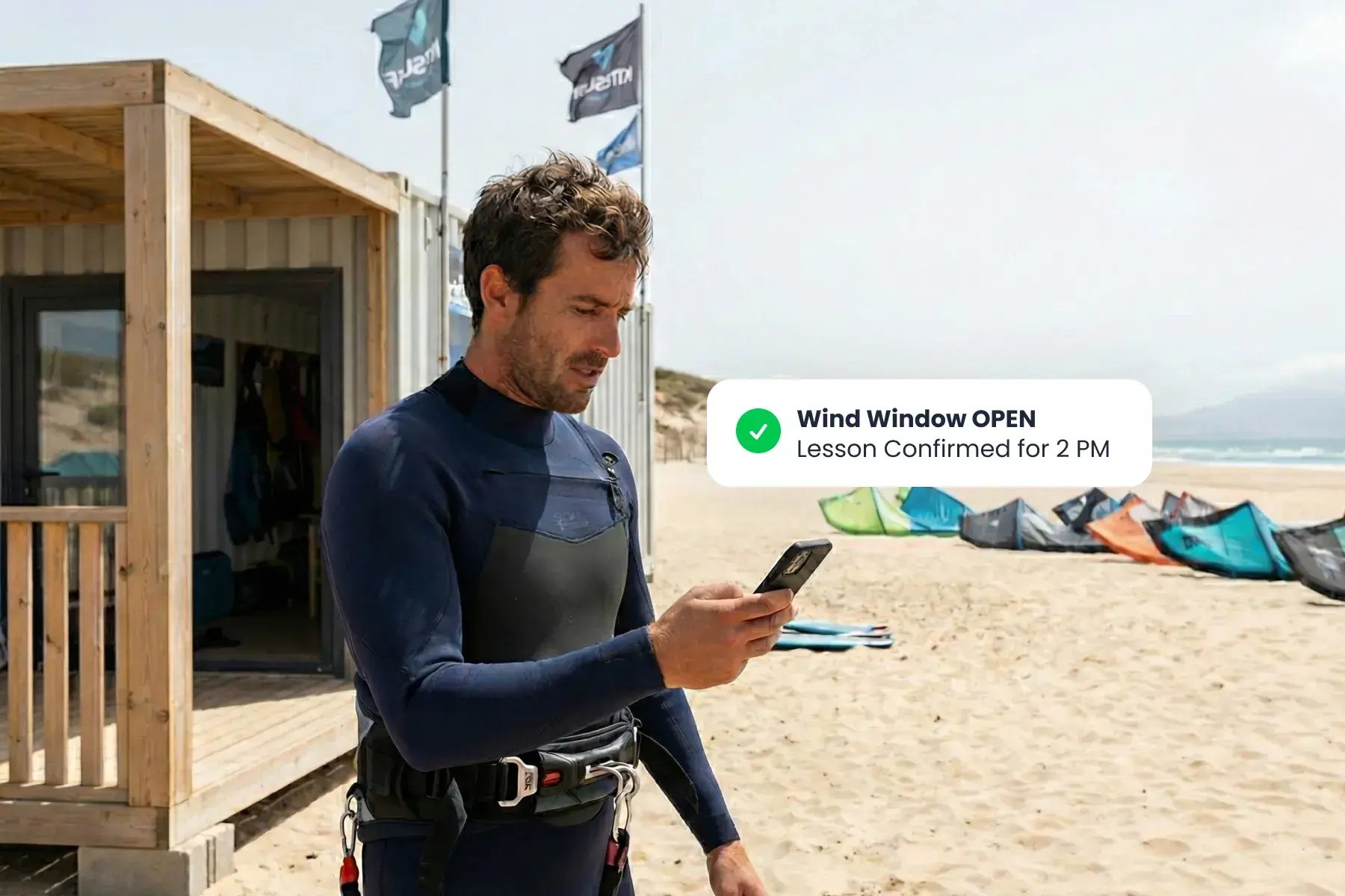 Staff member using Bloowatch on the beach to manage wind-smart scheduling, instructor planning, and daily operations.