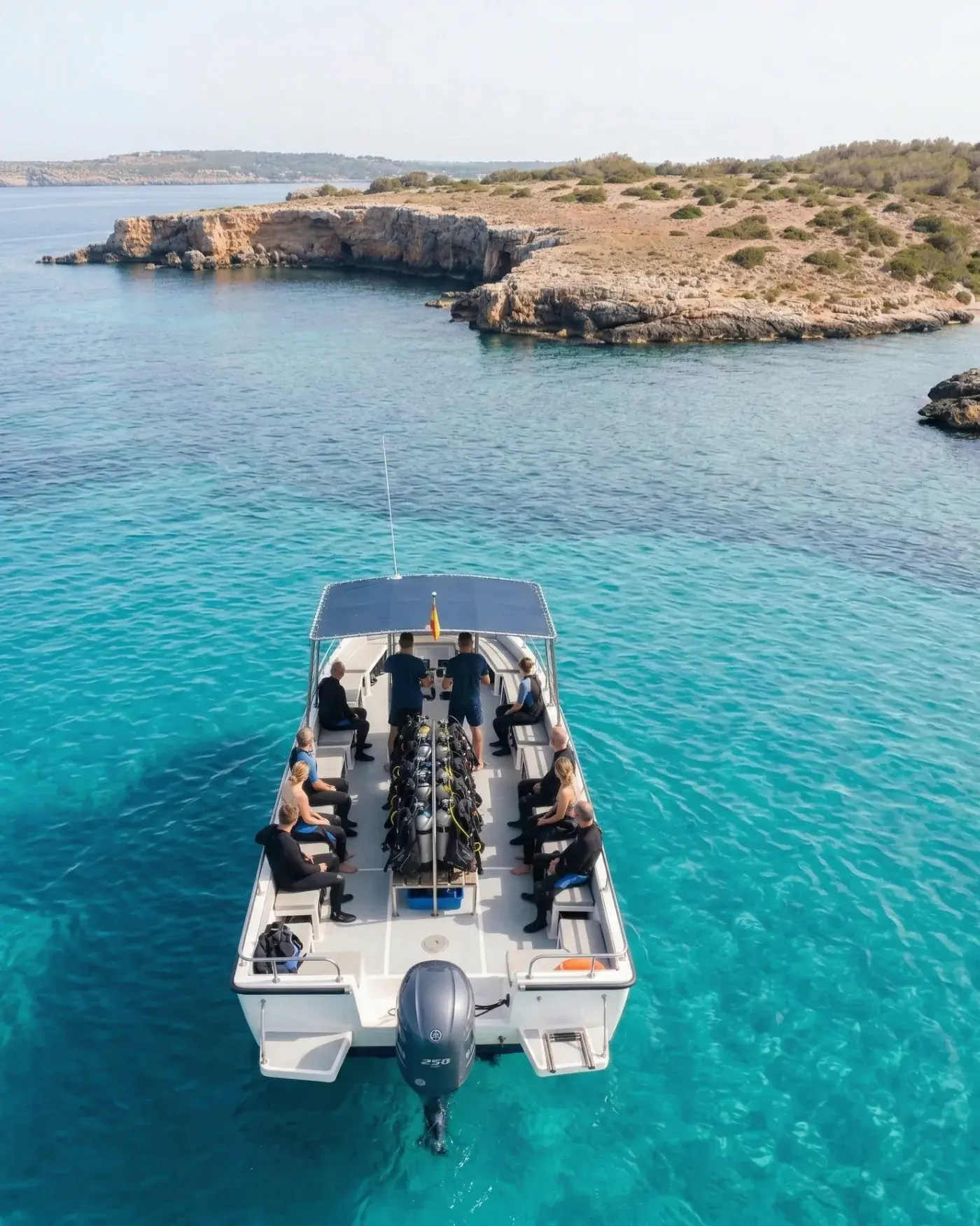 Aerial view of a dive boat on turquoise Mediterranean water, illustrating Bloowatch dive center management from first booking to final dive